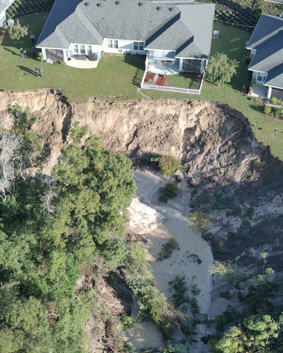 Photo: About 18 inches of rain washes away ground just a few feet from Florida homes